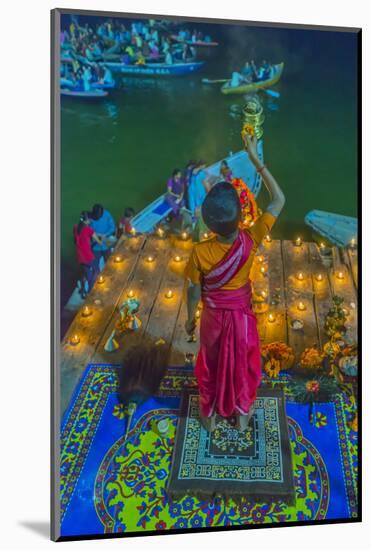 India, Varanasi Young Boy in Pink and Yellow Robes Holds Up an Offering to the Ganges River-Ellen Clark-Mounted Photographic Print