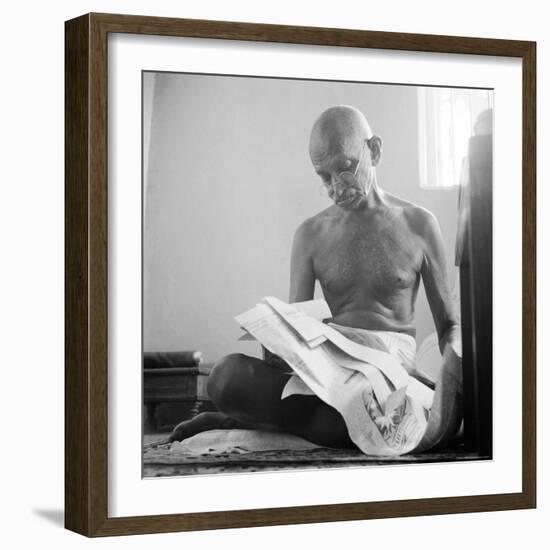 Indian Leader Mohandas Gandhi Reading as He Sits Cross Legged on Floor, at Home-Margaret Bourke-White-Framed Premium Photographic Print