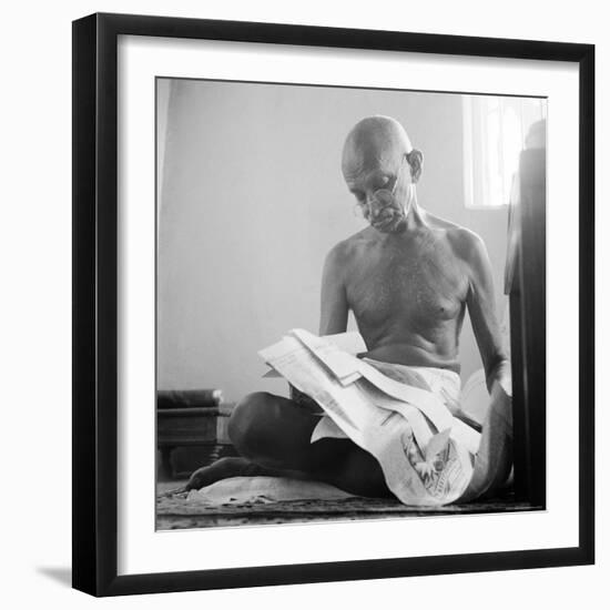 Indian Leader Mohandas Gandhi Reading as He Sits Cross Legged on Floor, at Home-Margaret Bourke-White-Framed Premium Photographic Print