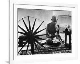 Indian Leader Mohandas Gandhi Reading as He Sits Cross Legged on Floor-Margaret Bourke-White-Framed Premium Photographic Print