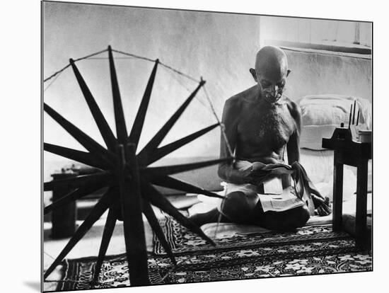 Indian Leader Mohandas Gandhi Reading as He Sits Cross Legged on Floor-Margaret Bourke-White-Mounted Premium Photographic Print