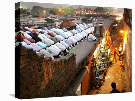 Indian Muslims During Friday Evening Prayers on the Rooftop of a Building over an Auto Parts Market-null-Stretched Canvas
