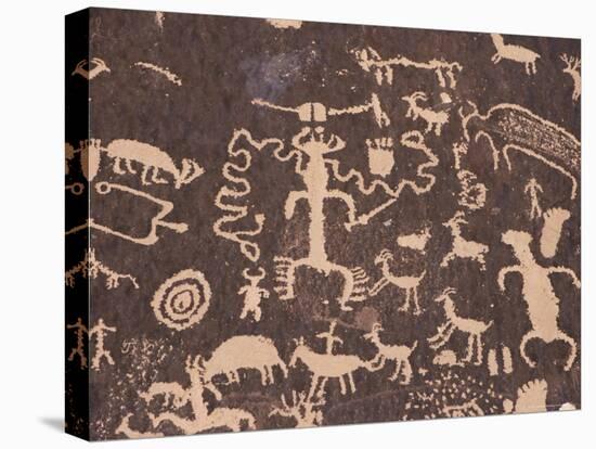 Indian Petroglyphs Drawn on Red Standstone by Scratching Away Dark Desert Varnish of Iron Oxides-Tony Waltham-Stretched Canvas