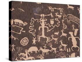 Indian Petroglyphs Drawn on Red Standstone by Scratching Away Dark Desert Varnish of Iron Oxides-Tony Waltham-Stretched Canvas
