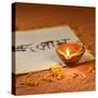 Indian Traditional Lamp Placed on a Book with Sanskrit Calligraphy-satel-Stretched Canvas