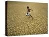 Indian Village Boy Runs Through a Parched Field on World Water Day in Berhampur, India-null-Stretched Canvas