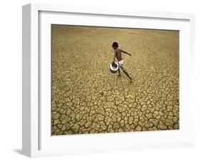 Indian Village Boy Runs Through a Parched Field on World Water Day in Berhampur, India-null-Framed Photographic Print