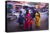 Indian women in colourful saris walk along streets-Charles Bowman-Stretched Canvas