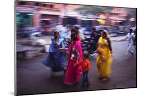 Indian women in colourful saris walk along streets-Charles Bowman-Mounted Photographic Print