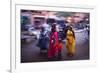 Indian women in colourful saris walk along streets-Charles Bowman-Framed Photographic Print