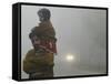 Indian Worker Carries His Daughter in the Morning Fog in the Outskirts of Jammu, India-null-Framed Stretched Canvas