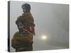 Indian Worker Carries His Daughter in the Morning Fog in the Outskirts of Jammu, India-null-Stretched Canvas