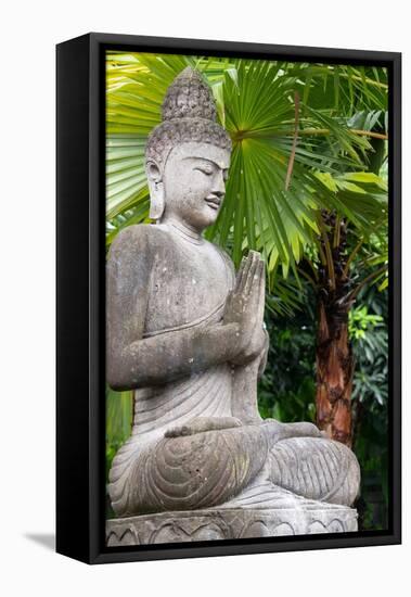 Indonesia, Bali. Buddha statue with green palms.-Cindy Miller Hopkins-Framed Stretched Canvas