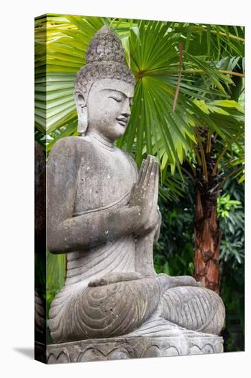 Indonesia, Bali. Buddha statue with green palms.-Cindy Miller Hopkins-Stretched Canvas