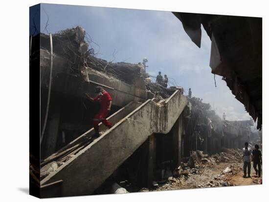 Indonesian Rescue Workers Walk on a Eartquake Damaged Building, in Padang, Indonesia-null-Stretched Canvas
