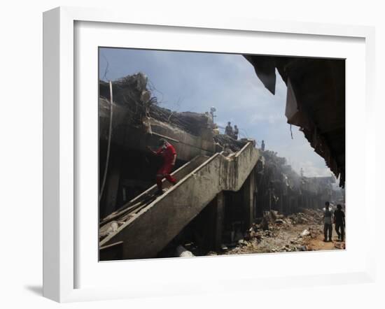 Indonesian Rescue Workers Walk on a Eartquake Damaged Building, in Padang, Indonesia-null-Framed Photographic Print