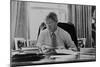 Informal Portrait of President Bill Clinton at His Desk in the Oval Office-null-Mounted Premium Photographic Print