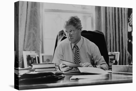 Informal Portrait of President Bill Clinton at His Desk in the Oval Office-null-Stretched Canvas