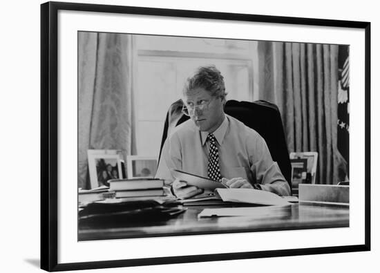 Informal Portrait of President Bill Clinton at His Desk in the Oval Office-null-Framed Photo