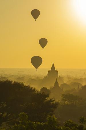 Myanmar. Bagan. Hot Air Balloons Rising over the Temples of Bagan