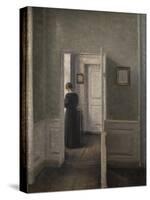 Interior with a woman standing-Vilhelm Hammershoi-Stretched Canvas