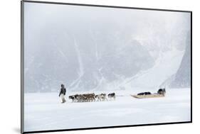 Inuit Hunter Walking His Dog Team on the Sea Ice in a Snow Storm, Greenland, Denmark, Polar Regions-Louise Murray-Mounted Photographic Print