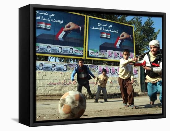 Iraqi Boys Play Soccer Below the Poster Reading "To Grant Iraqi Children Better Iraq"-null-Framed Stretched Canvas