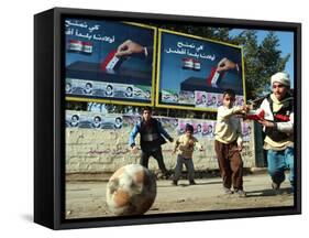 Iraqi Boys Play Soccer Below the Poster Reading "To Grant Iraqi Children Better Iraq"-null-Framed Stretched Canvas