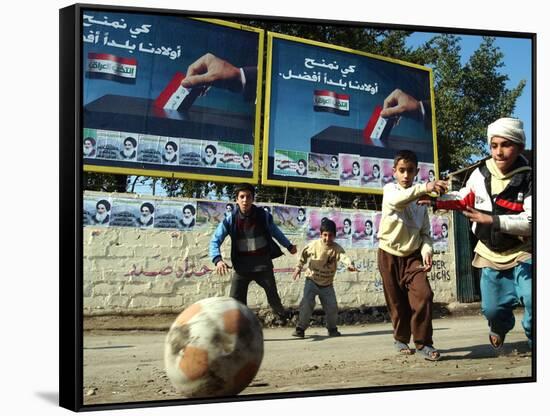 Iraqi Boys Play Soccer Below the Poster Reading "To Grant Iraqi Children Better Iraq"-null-Framed Stretched Canvas