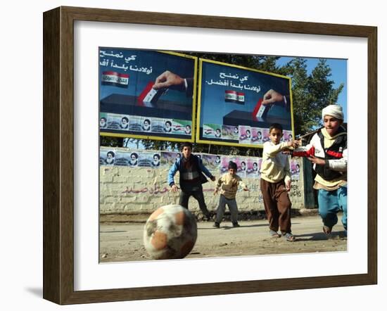 Iraqi Boys Play Soccer Below the Poster Reading "To Grant Iraqi Children Better Iraq"-null-Framed Premium Photographic Print