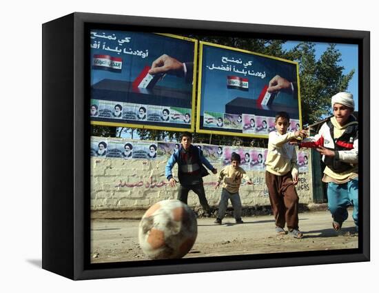 Iraqi Boys Play Soccer Below the Poster Reading "To Grant Iraqi Children Better Iraq"-null-Framed Stretched Canvas