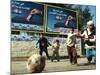 Iraqi Boys Play Soccer Below the Poster Reading "To Grant Iraqi Children Better Iraq"-null-Mounted Photographic Print