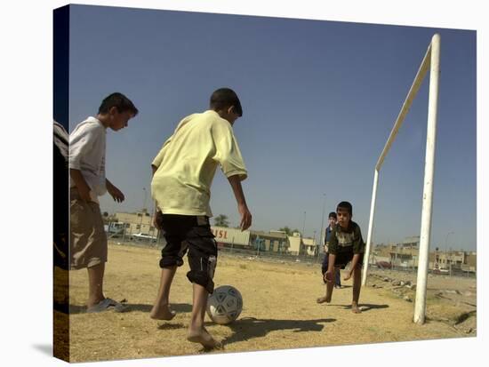 Iraqi Boys Play Soccer in a Baghdad Neighborhood-null-Stretched Canvas