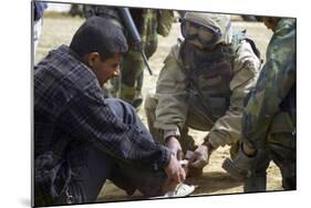Iraqi Detainee Receives a Bandage While under Interrogation, March 24, 2003-null-Mounted Photo