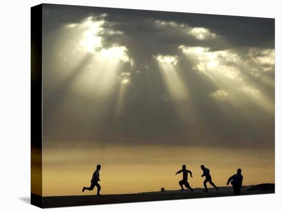 Iraqi Kurdish Boys Play Football as the Sun Sets-null-Stretched Canvas