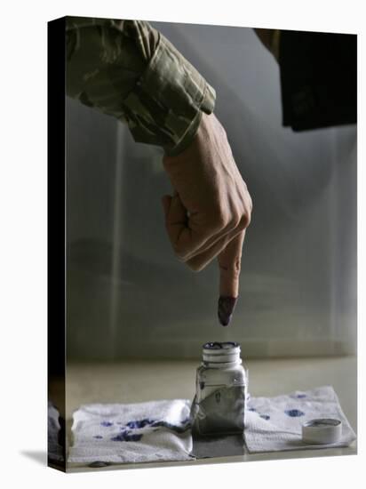 Iraqi Security Forces Member Inks His Finger after Casting His Vote at a Polling Center in Iraq-null-Stretched Canvas