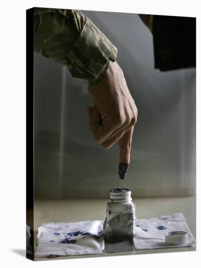Iraqi Security Forces Member Inks His Finger after Casting His Vote at a Polling Center in Iraq-null-Stretched Canvas
