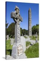 Ireland, County Wicklow, Glendalough, Celtic cross and Round Tower-Walter Bibikow-Stretched Canvas