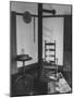 Iron Woodstove with a Ladder Backed Wooden Armchair in a Restored Shaker Parlor-John Loengard-Mounted Photographic Print