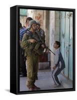 Israeli Soldier Tells a Palestinian Boy to Leave the Scene Following a Knife Attack-null-Framed Stretched Canvas