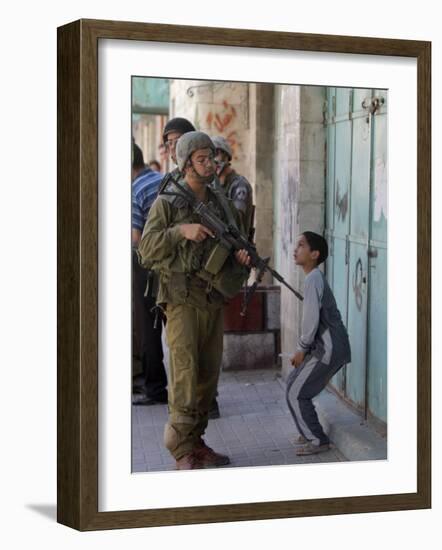 Israeli Soldier Tells a Palestinian Boy to Leave the Scene Following a Knife Attack-null-Framed Photographic Print