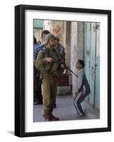 Israeli Soldier Tells a Palestinian Boy to Leave the Scene Following a Knife Attack-null-Framed Photographic Print