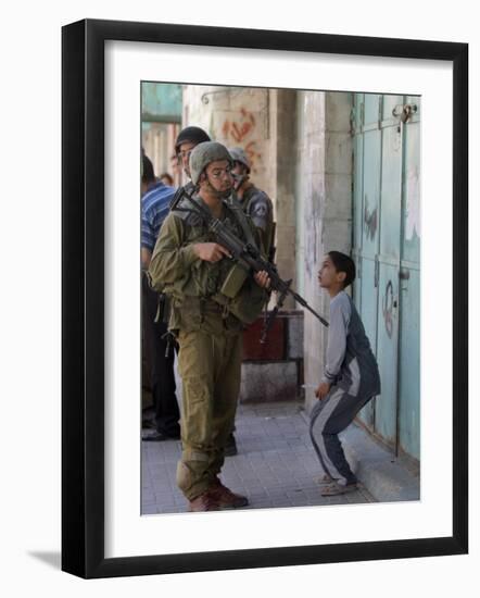 Israeli Soldier Tells a Palestinian Boy to Leave the Scene Following a Knife Attack-null-Framed Photographic Print