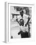 Italian Man Leaping Onto a Friend's Back in Casual Greeting While Crossing a Piazza-Paul Schutzer-Framed Photographic Print