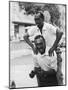 Italian Man Leaping Onto a Friend's Back in Casual Greeting While Crossing a Piazza-Paul Schutzer-Mounted Photographic Print
