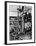 Italian Physicist Enrico Fermi Peering Out from Behind Large, Complicated Machinery in Laboratory-Ralph Morse-Framed Premium Photographic Print