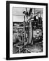 Italian Physicist Enrico Fermi Peering Out from Behind Large, Complicated Machinery in Laboratory-Ralph Morse-Framed Premium Photographic Print