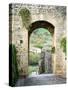 Italy, Chianti, Monteriggioni. Looking out an arched entrance into the walled town.-Julie Eggers-Stretched Canvas