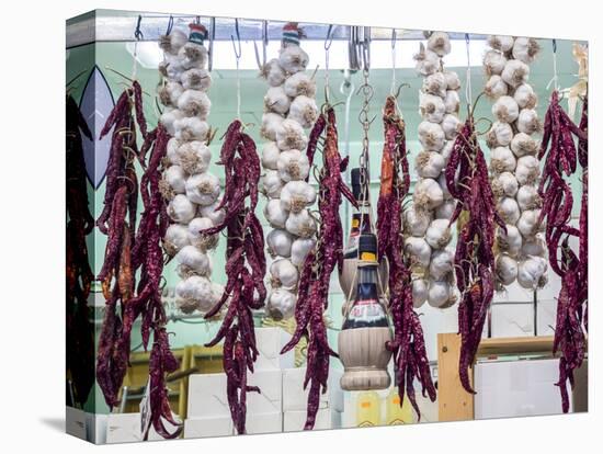 Italy, Florence. Garlic and peppers for sale hanging in a shop in the Central Market-Julie Eggers-Stretched Canvas