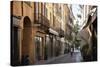 Italy, Lombardy, Cremona, cobblestone street with bicycles and old buildings-Alan Klehr-Stretched Canvas